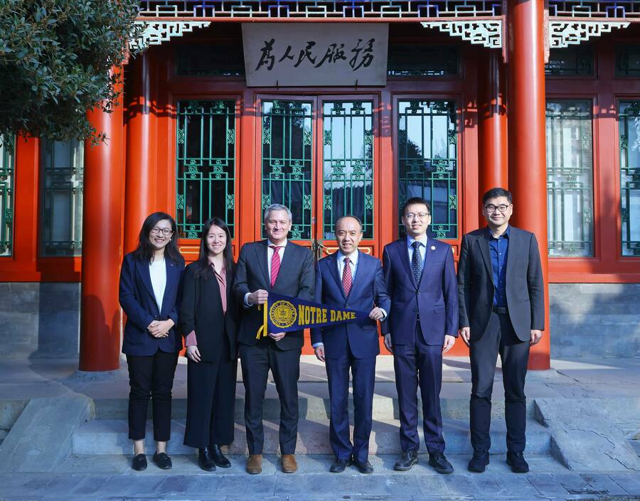 Michael Pippenger and Hongwei Wang stand with group.